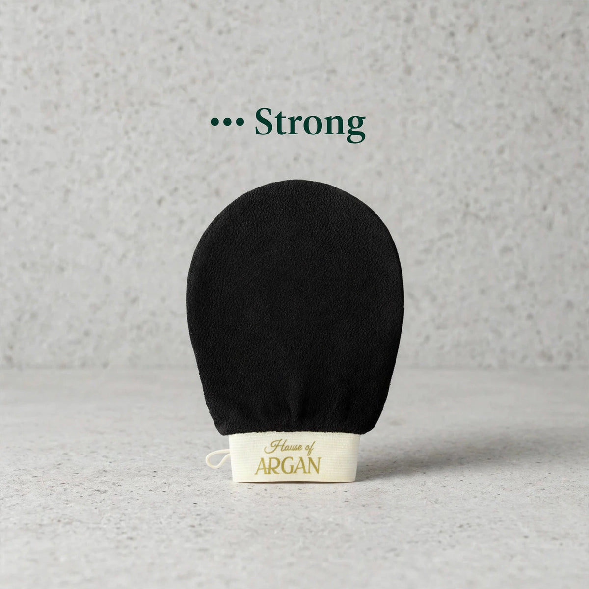 House of Argan black Moroccan kessa glove for strong body exfoliation, displayed upright on a neutral background
