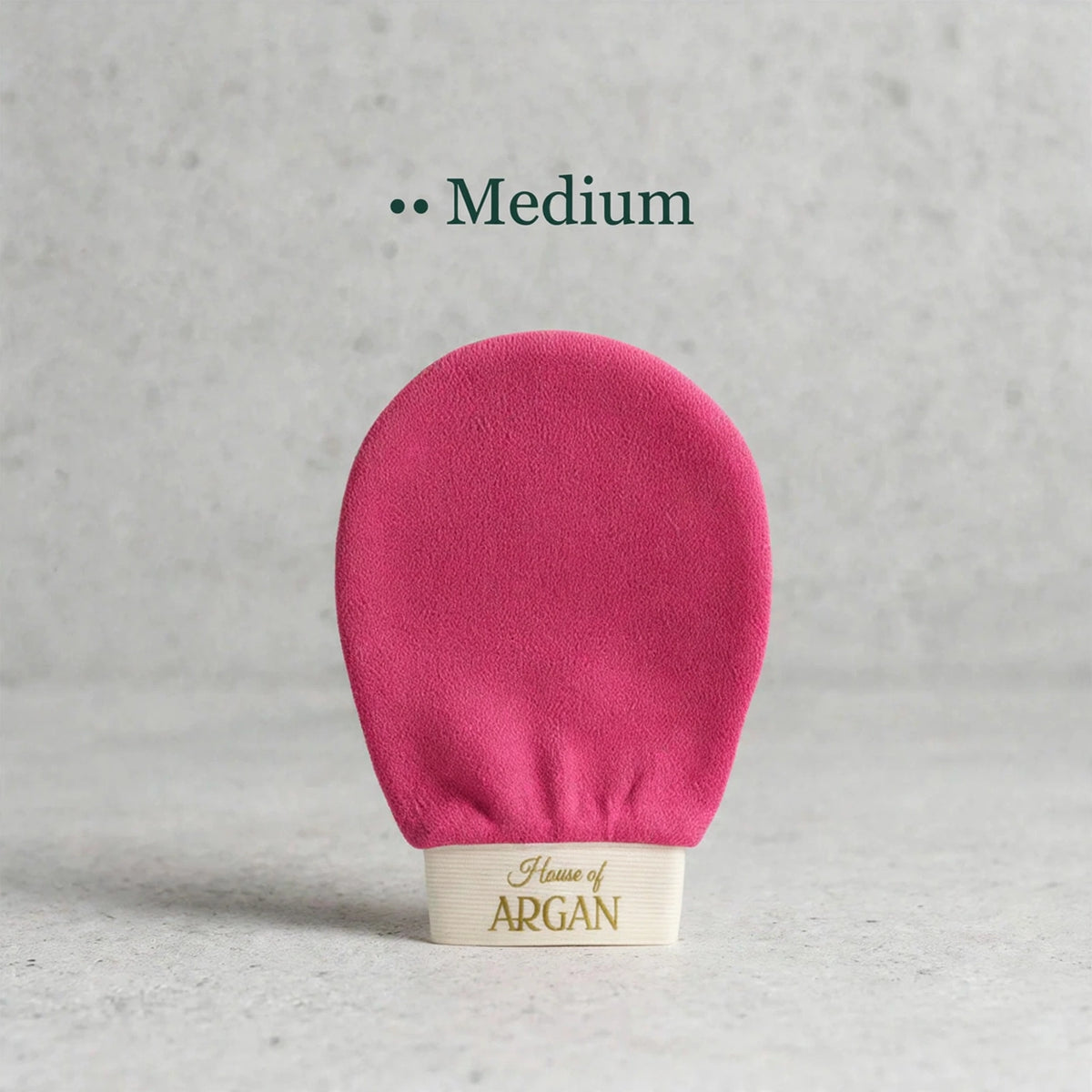 House of Argan fuchsia Moroccan kessa glove for medium body exfoliation, displayed upright on a neutral background
