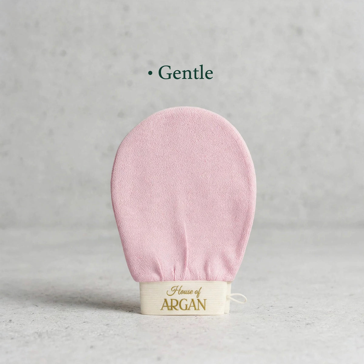 House of Argan pink Moroccan kessa glove for gentle body exfoliation, displayed upright on a neutral background
